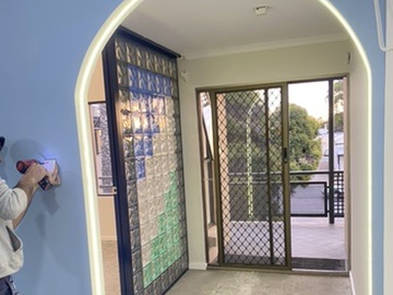 Custom arched LED light strip installed in a luxury residential entrance way