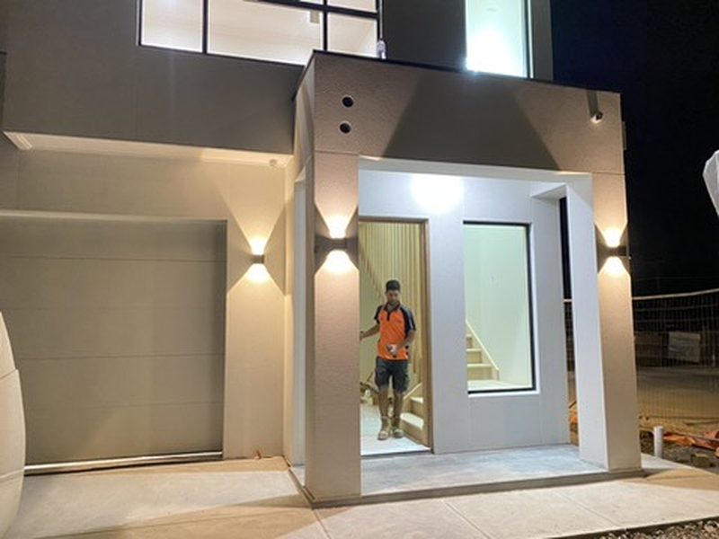 Adelaide luxury home exterior at night with up/down wall lighting and recessed entry lights